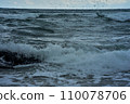 rocky seashore, surf and waves are broken by splashes and foam 110078706