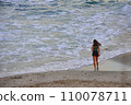 A thoughtful and romantic girl on the seashore at sunset admires the warm sea and clean air 110078711