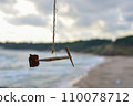 a primitive children's weather vane in the form of a small airplane made of wood and tree bark on the seashore 110078712