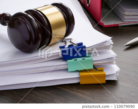 A stack of accounting papers and gavel. Financial white-collar crime and embezzlement. 110079090