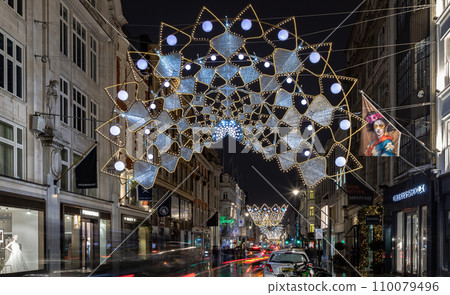Christmas crowns decoration led lights display. Dramatic view of the traditional Christmas decoration lights hanging above Bond street during dusk. 110079496