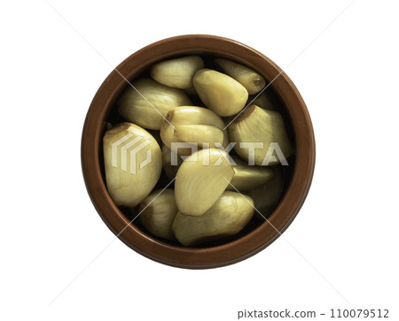 Garlic pickled in Apple cider vinegar with Rock sugar in jar bowl isolated on white background with clipping path. 110079512