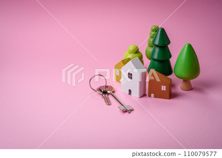 A small wooden house and keys as an idea for investing in your own home and achieving the goal of buying real estate A small wooden house and keys as an idea for investing in your own home and achieving the goal of buying real estate 110079577