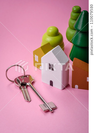 A small wooden house and keys as an idea for investing in your own home and achieving the goal of buying real estate A small wooden house and keys as an idea for investing in your own home and achieving the goal of buying real estate 110079580