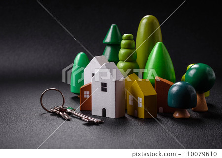 A small wooden house and keys as an idea for investing in your own home and achieving the goal of buying real estate A small wooden house and keys as an idea for investing in your own home and achieving the goal of buying real estate 110079610