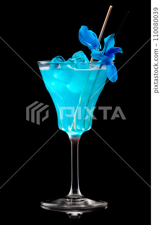 Blue Curacao cocktail garnished with a lime isolated on black background 110080039