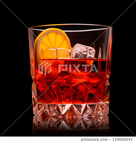 Classic Negroni in a crystal-cut rocks glass isolated on black backdrop 110080041