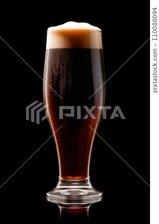 Beer in a tall glass on a dark black background. Mugs with drink like Ipa, Pale Ale, Pilsner, Porter or Stout Beer in a tall glass on a dark black background. Mugs with drink like Ipa, Pale Ale, Pilsner, Porter or Stout 110080094