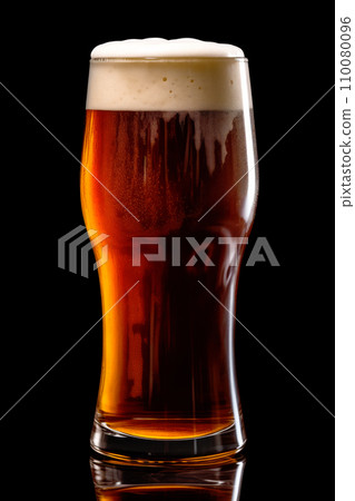 Beer in a tall glass on a dark black background. Mugs with drink like Ipa, Pale Ale, Pilsner, Porter or Stout 110080096