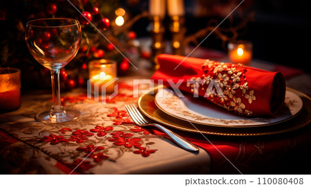 Christmas table with candles, plates and red napkins in front of Christmas trees on bokeh and warm brown background 110080408