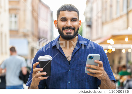 Young adult man use smartphone typing text messages browsing internet finishing work chatting online Young adult man use smartphone typing text messages browsing internet finishing work chatting online 110080586