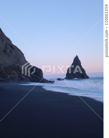 Reynisfjara rock formations on beach with black sand and pink sky near reynisfjall mountain, unique ocean coastline. Amazing stones on shoreline forming natural icelandic landscape, wonderland. Reynisfjara rock formations on beach with black sand and pink sky near reynisfjall mountain, unique ocean coastline. Amazing stones on shoreline forming natural icelandic landscape, wonderland. 110081359