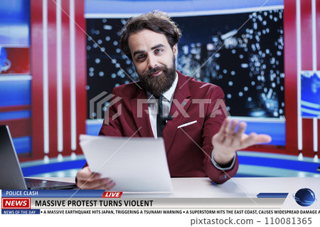 Newscaster covers protest news topic, talking about massive demonstration with crowd of people on strike. Journalist presenting report about violent community protesting, live talk show. 110081365