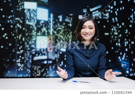 TV reporter hosting late night talk show to cover daily news, presenting live information on worldwide transmission. Woman journalist working as presenter to address important topics. 110081394