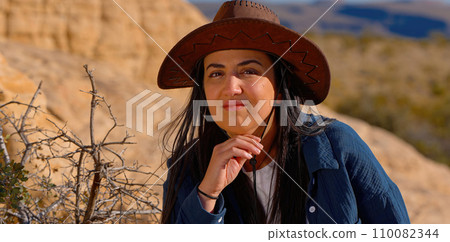 Close up shot of a young woman in a western style outfit in the Arizona desert Close up shot of a young woman in a western style outfit in the Arizona desert 110082344