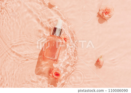 Cosmetics on water background of trendy peach colour. Hyaluronic acid skin care for youthful skin. Cosmetics on water background of trendy peach colour. Hyaluronic acid skin care for youthful skin. 110086090