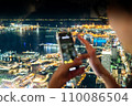 A woman taking pictures of the night view of Yokohama 110086504