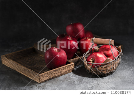 red apples in a wicker basket on dark background red apples in a wicker basket on dark background 110088174
