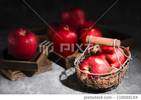 red apples in a wicker basket on dark background red apples in a wicker basket on dark background 110088184