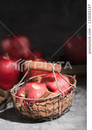red apples in a wicker basket on dark background red apples in a wicker basket on dark background 110088187