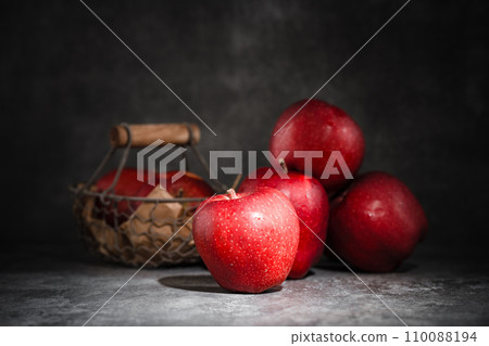 red apples in a wicker basket on dark background red apples in a wicker basket on dark background 110088194