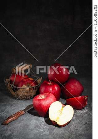 red apples in a wicker basket on dark background red apples in a wicker basket on dark background 110088202