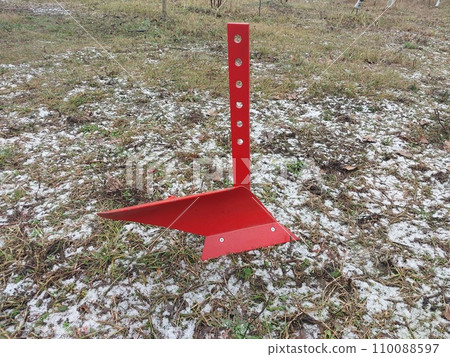 Red mini plow on a winter field 110088597