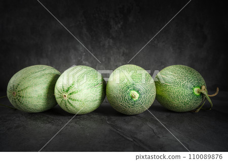 Fresh honeydew melon on dark background 110089876