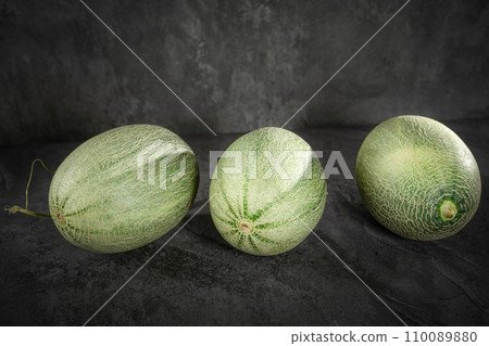 Fresh honeydew melon on dark background 110089880