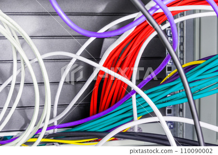 bunch of patch network cables sorted in rack cabinet, leading from patch panel in the server rack in the data center room bunch of patch network cables sorted in rack cabinet, leading from patch panel in the server rack in the data center room 110090002