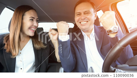 Happy office workers sit in car and rejoice with project 110090036