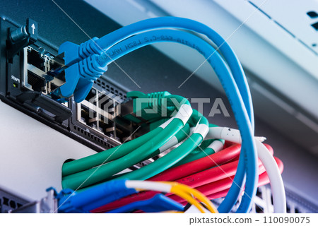 fiber optic cables connected to optic ports, network cables connected to ethernet ports fiber optic cables connected to optic ports, network cables connected to ethernet ports 110090075