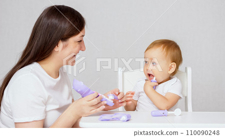 Mother engaged in development of child girl playing game Mother engaged in development of child girl playing game 110090248