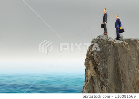 Businessmen on a cliff overlooking the sea - AI-generated image 110091569