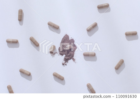 Gray hard capsules are randomly arranged on a white background. Capsules are convenient to use and easy to store and transport because they are dosed and packaged neatly like tablets. Gray hard capsules are randomly arranged on a white background. Capsules are convenient to use and easy to store and transport because they are dosed and packaged neatly like tablets. 110091630