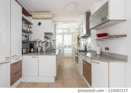 Kitchen zone equipped with cooking appliances and furniture 110092337