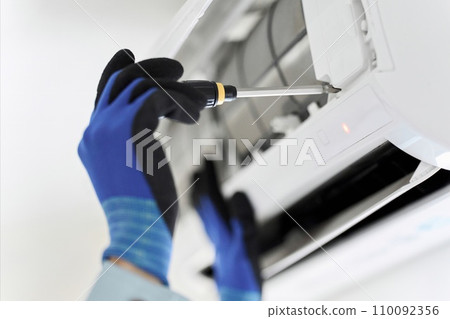 Asian worker inspecting air conditioner Asian worker inspecting air conditioner 110092356