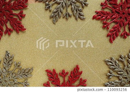 Six large silver and red flat ornate snowflakes are laid out on velvety gold paper. Free space for text. New Year or Christmas background for advertising. Festive winter flatlay. Yellow red gray color Six large silver and red flat ornate snowflakes are laid out on velvety gold paper. Free space for text. New Year or Christmas background for advertising. Festive winter flatlay. Yellow red gray color 110093256