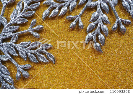 Two large silver flat ornate snowflakes are laid out on velvety gold paper. Free space for text. New Year or Christmas background for advertising. Festive winter flat lay. Yellow and gray background. Two large silver flat ornate snowflakes are laid out on velvety gold paper. Free space for text. New Year or Christmas background for advertising. Festive winter flat lay. Yellow and gray background. 110093268