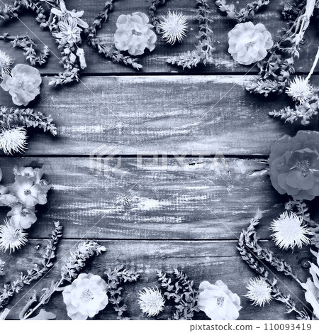 Flowers in a circle on a wooden background. Postcard roses, geraniums, lavender, sage and hairy chestnuts are placed along the edges. Background copy space, flat lay. Monochrome white - black photo. Flowers in a circle on a wooden background. Postcard roses, geraniums, lavender, sage and hairy chestnuts are placed along the edges. Background copy space, flat lay. Monochrome white - black photo. 110093419