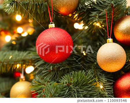 Beautiful red, gold, silver, yellow, beige shiny and matte Christmas balls shine on a spruce branch. Happy New Year. Merry Christmas. Christmas background - baubles and branch of spruce tree. Beautiful red, gold, silver, yellow, beige shiny and matte Christmas balls shine on a spruce branch. Happy New Year. Merry Christmas. Christmas background - baubles and branch of spruce tree. 110093546