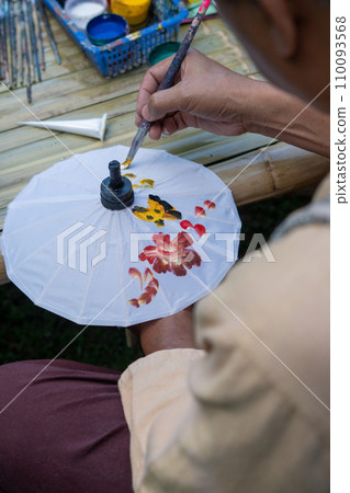 painting on Handmade umbrella of the village Bo Sang, Chiang mai, Thailand. 110093568