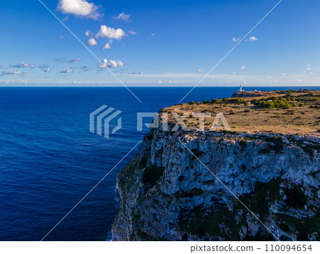 Lighthouse on Cliff Overlooking the Infinite Sea and Sky Lighthouse on Cliff Overlooking the Infinite Sea and Sky 110094654