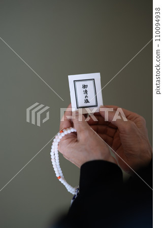 葬禮結束後，一位婦女的手上拿著念珠和鹽，供清朝使用。 110094938