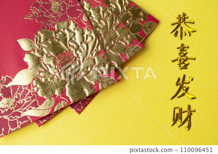 Chinese New Year red packets on yellow cover background with GongXi FaCai wishes 110096451
