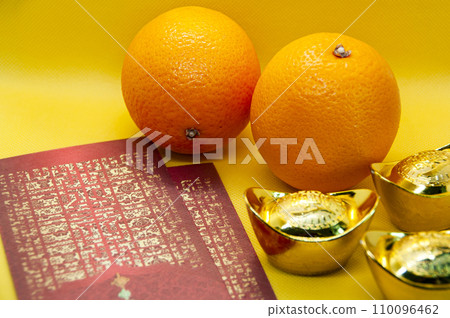 Chinese New Year decoration with oranges, dark red packets and gold ingots on yellow cover background. Chinese festive season concept and copy space. Chinese New Year decoration with oranges, dark red packets and gold ingots on yellow cover background. Chinese festive season concept and copy space. 110096462