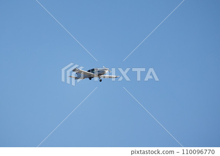 Light single-engine aircraft is in blue sky Light single-engine aircraft is in blue sky 110096770