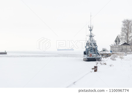 Gray industrial ship is moored in winter port Gray industrial ship is moored in winter port 110096774