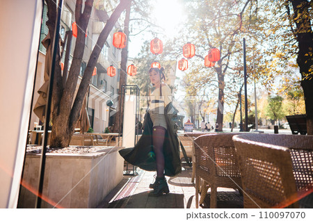 Full length portrait of Asian woman in front of Chinese lanterns.  110097070