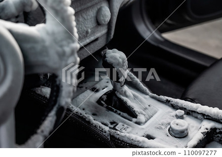 Car interior in a layer of cleaning foam.  110097277